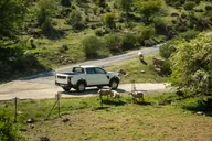 KGM Musso D22 Pro, lateral trasero en un camino de montaña